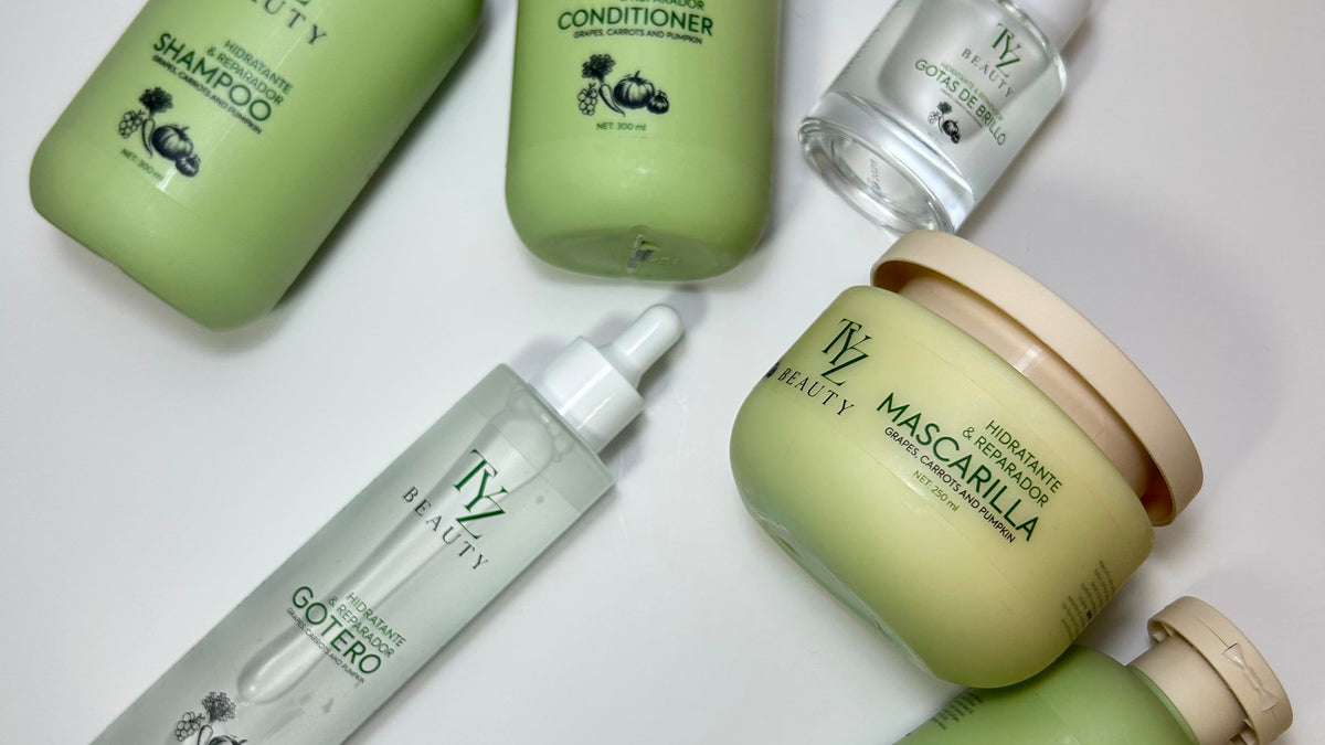 A set of six TYZ Beauty hair care products arranged on a plain white surface, including bottles, jars, and a dropper bottle in sage green and clear packaging.