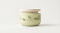 A jar of TYZ Beauty Hydrated & Repairing Mascarilla hair mask, featuring a pale sage green container and a light beige lid, set against a clean white background.